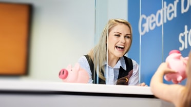 Greater Bank staff member serving customer - Mobile version