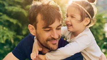Father and daughter playing in garden
