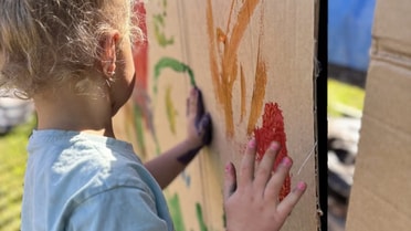 Image of a child finger painting