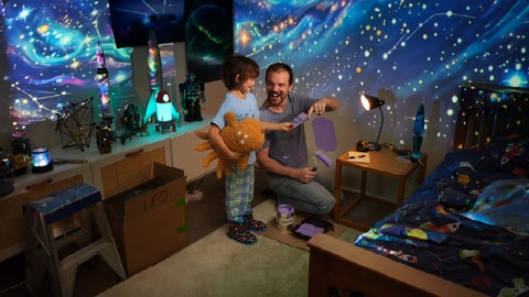 Father and son choosing paint colours as the begin a space themed renovation on the child bedroom