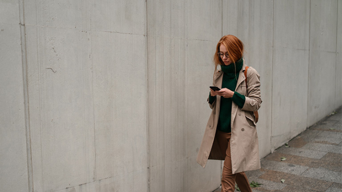 Woman walking down the street on phone