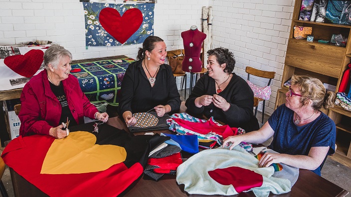 Women knitting a quilt
