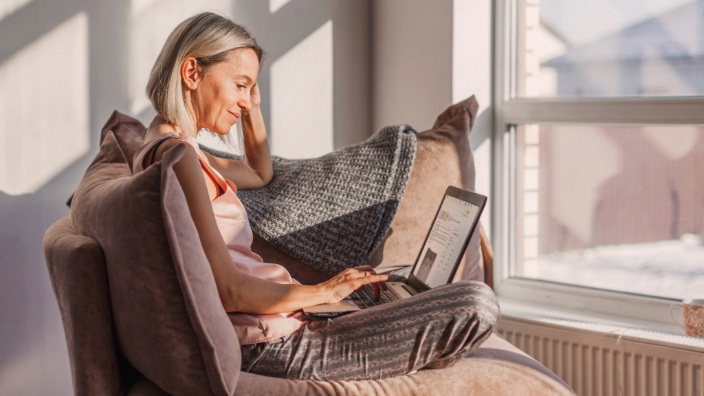 Blonde woman using laptop